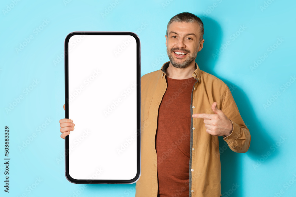 Poster man showing large smartphone advertising application over blue background, mockup
