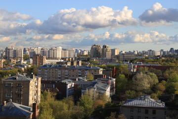 Fototapeta na wymiar Panorama of the southern administrative district of the city of Moscow on a spring sunny day with expressive clouds in the blue sky.