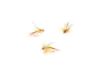 Three fly fishing lures in different files, colors and hook sizes isolated on white background
