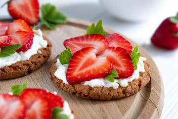 Homemade strawberry tart with oat biscuit and whipped cream. Recipe of simple berry cake for breakfast or holiday. Summer light dessert.