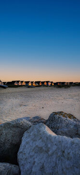 Beautiful view of the sunrise with beach huts in Mudeford Quey, Bournemouth