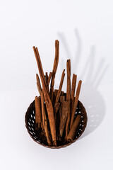 Cinnamon sticks and dried cloves on a white background.