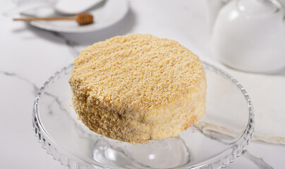 Shortbread cake Napoleon stands on a white table