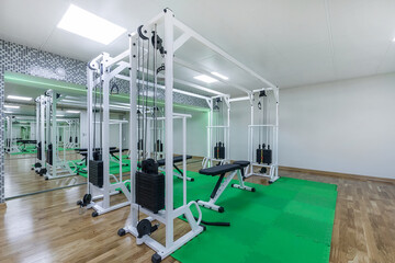 Fototapeta na wymiar A modern, bright gym with mirrors and sports equipment.