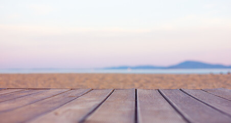 Fototapeta na wymiar wooden flooring from brown boards on a sandy beach near the sea