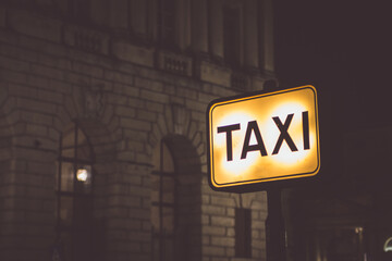 View of illuminated taxi sign at night