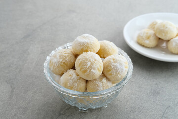 Kue Putri Salju or Snow White Cookies with crescent shaped. Made from flour, sugar and butter coated with powdered sugar. Popular to celebrate Eid al Fitr. Selective focus image.
