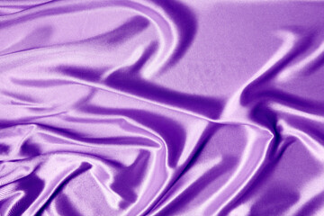 gold beautiful satin fabric draped with soft folds, silk cloth background, close-up, copy space