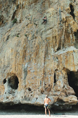 Vertical shot of a free climber in action while climbing a rocky wall  Cilento, Campania, Italy