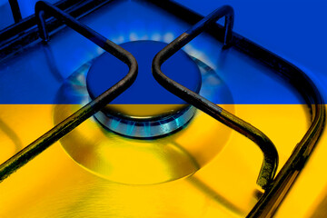 Close up of Household gas burner blue flame, flag of the European state of Ukraine on the burner of...