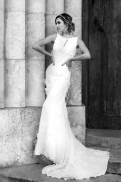 Model posing in a wedding dress on a staircase, black and white photo