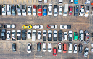 Aerial top view of cars in parking lots with street road in urban city. Transportation and vehicles