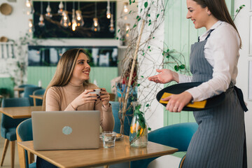 woman ordering food in lounge bar