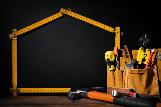 home improvement and repair. construction tools on black background with copy space