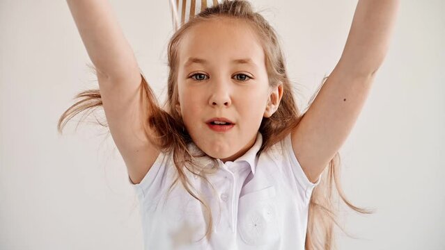 Child on birthday heat blows on confetti in the form of stars from her palms during a holiday
