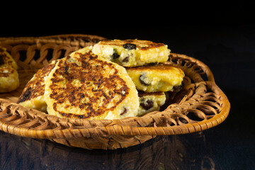 Fried cottage cheese with raisins on a glass table