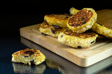 Fried cottage cheese with raisins on a glass table
