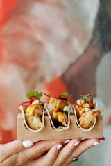 Girl holding shrimps tacos in hand food lifestyle photo