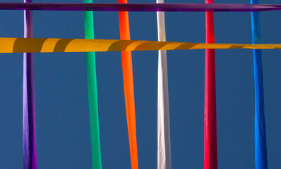 Bars with colored ribbons in the blue sky