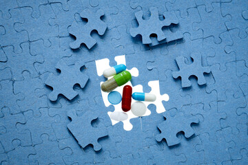 pills and medicine in capsules on the missing puzzle piece, concept of generics, clinical trial of drugs, dietary supplements