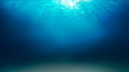 Sunlight shining through the surface of the blue ocean, sea, with dark waters and sandy seabed...