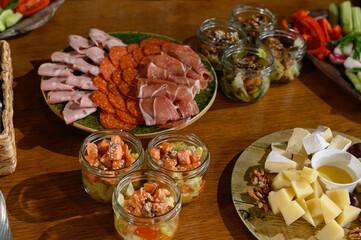 Wooden table with different types of snacks on holiday