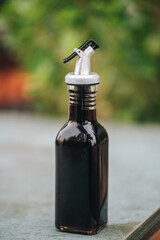 Fototapeta na wymiar soya sauce dispenser bottle with blurry background