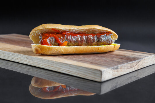 boerewors roll with relish on wooden board
