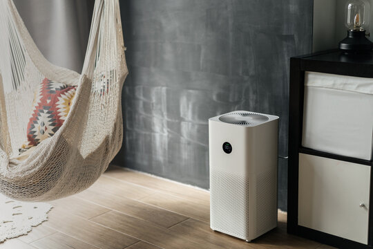 White air purifier from dust and viruses in the interior of the apartment next to the homak. Health and technology.