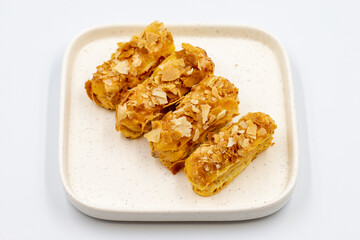 Cream eclairs cake. Eclair cake with cream filling on a white background. close up