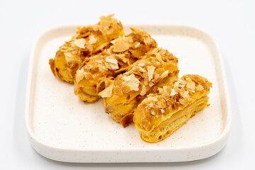 Cream eclairs cake. Eclair cake with cream filling on a white background. close up