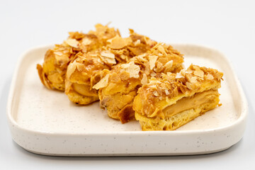 Cream eclairs cake. Eclair cake with cream filling on a white background. close up