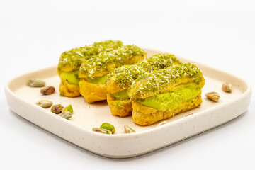 Pistachio eclair cake. Eclair cake with pistachio filling on a white background. close up