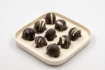 Special chocolate with dark outside and coconut inside. Dark chocolate with coconut filling on a white background. close up