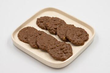 Special chocolate with hazelnut particles. Chocolate with hazelnuts on a white background. close up
