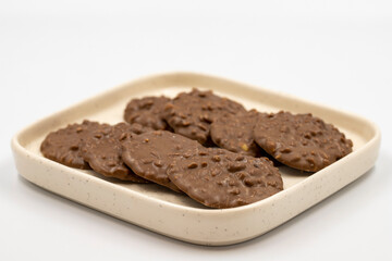 Special chocolate with hazelnut particles. Chocolate with hazelnuts on a white background. close up