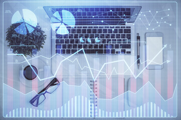 Obraz premium Multi exposure of forex chart drawing over table background with computer. Concept of financial research and analysis. Top view.