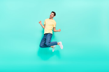 Fototapeta na wymiar Full body portrait of satisfied glad man raise fists celebrate triumph isolated on teal color background