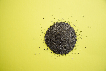 Pile of edible chia seeds from the Salvia hispanica plant. Image seen from above and isolated on...