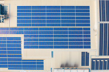 Aerial view of solar panels or solar cells on the roof of shopping mall building rooftop. Power plant, renewable clean energy source. Eco technology for electric power in industry.