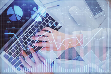 Double exposure of woman hands working on computer and forex chart hologram drawing. Top View. Financial analysis concept.
