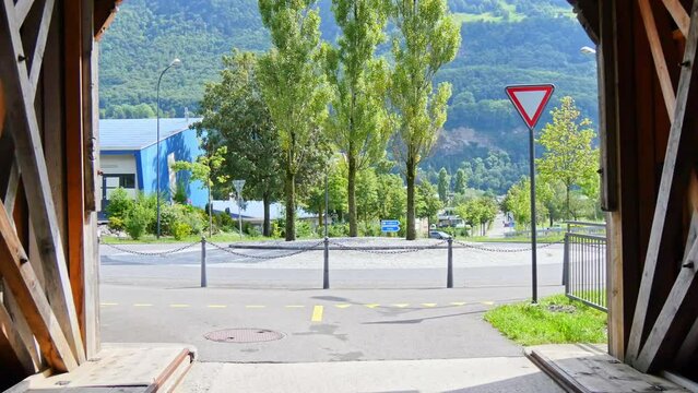 View from the Alte Rheinbrucke, an old wooden roofed bridge over the river Rhine on the border between municipalities of Vaduz in Liechtenstein and Sevelen in Switzerland.