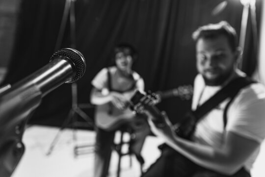 Repetition of rock music band at music studio. Cropped image of electric and acoustic guitar players at concert. Rehearsal base Concept of art, music, style