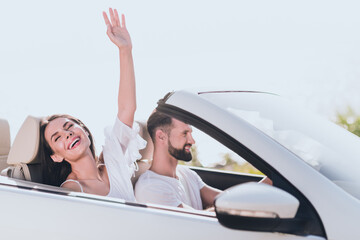 Photo of cute excited boyfriend girlfriend dressed casual outfits driving fast cabriolet outdoors...