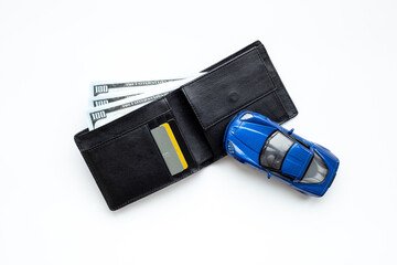 Purchase or rent a car concept. Toy car with wallet and money cash