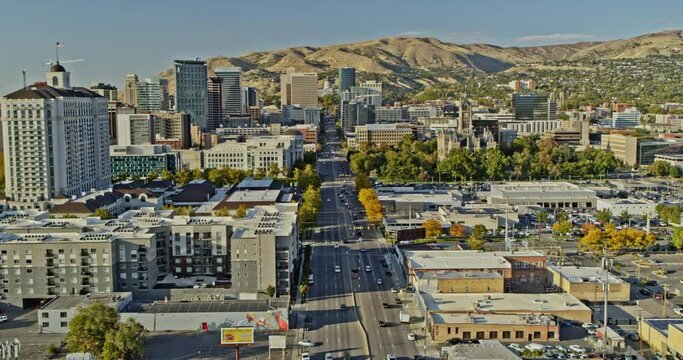 Salt Lake City Utah Aerial v22 low level dolly in shot, drone flyover state street capturing downtown cityscape with mountainous landscape background - Shot with Inspire 2, X7 camera - October 2021
