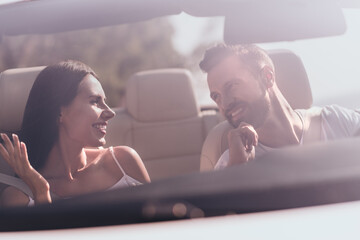 Photo of excited funny boyfriend girlfriend dressed casual outfits communicating driving cabriolet...