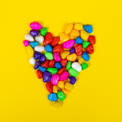 the shape of the heart formed with colored pebbles	
