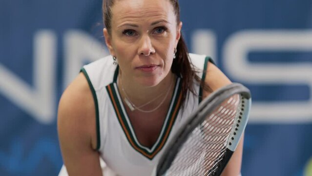 Potrait of Female Tennis Player Holding the Racquet During Championship Match, Ready for Receive Ball Strike. Professional Woman Athlete. Sports Broadcasting on TV Channel. Focus on Face Slow Motion