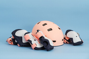 Top view of roller skates protective gear set - knee, elbow and wrist pads and helmet in pink...